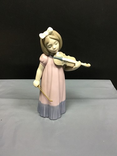 Nao lladro girl playing - by,