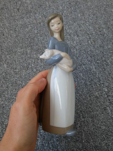 Lladro girl holding piglet